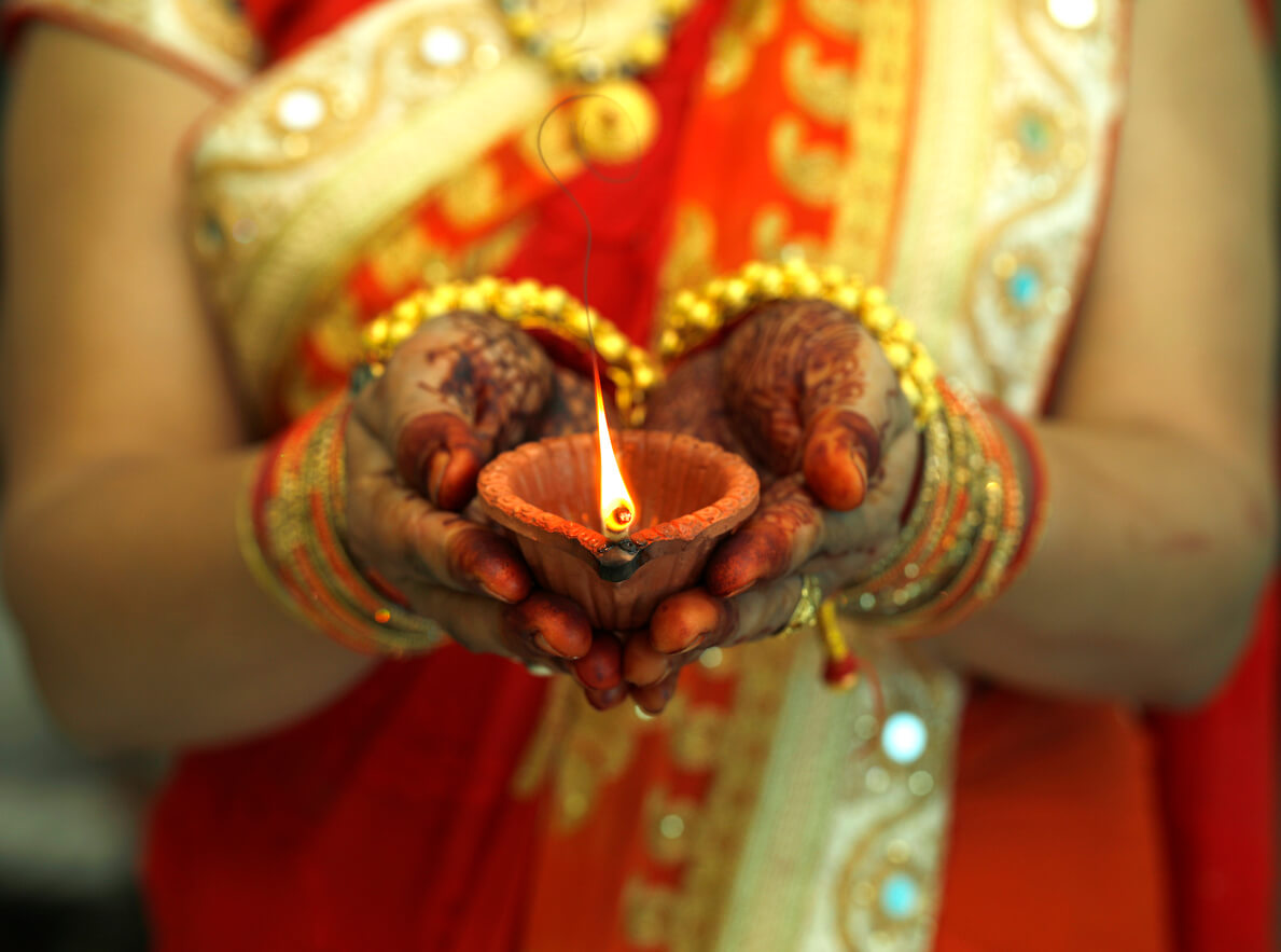 Indian woman holding Diwali oil lamp, Advaita vedanta